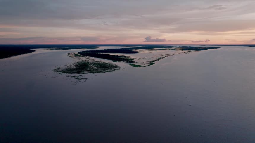 Aerial view of an island in a bay at sunset