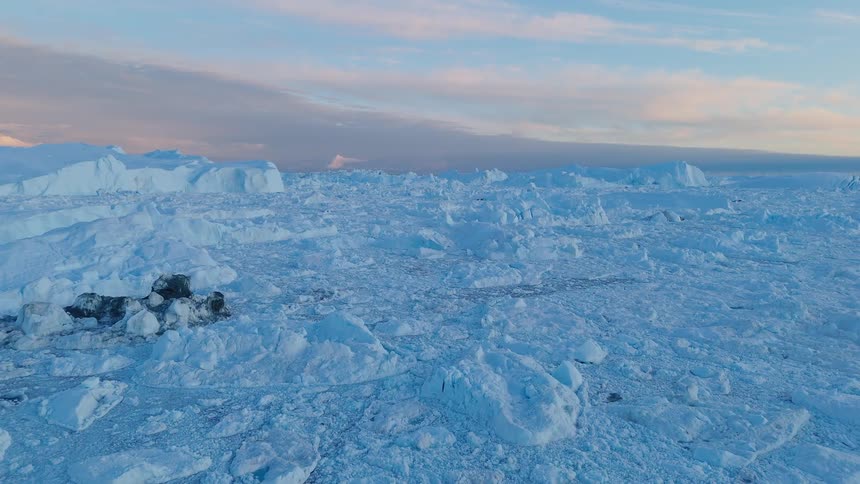 Snow covers the ground as the sun sets