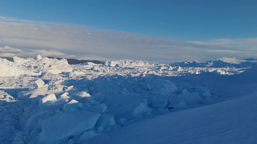 Sunlight shines on snow and ice across the arctic