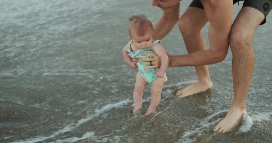 A couple and their baby at the beach