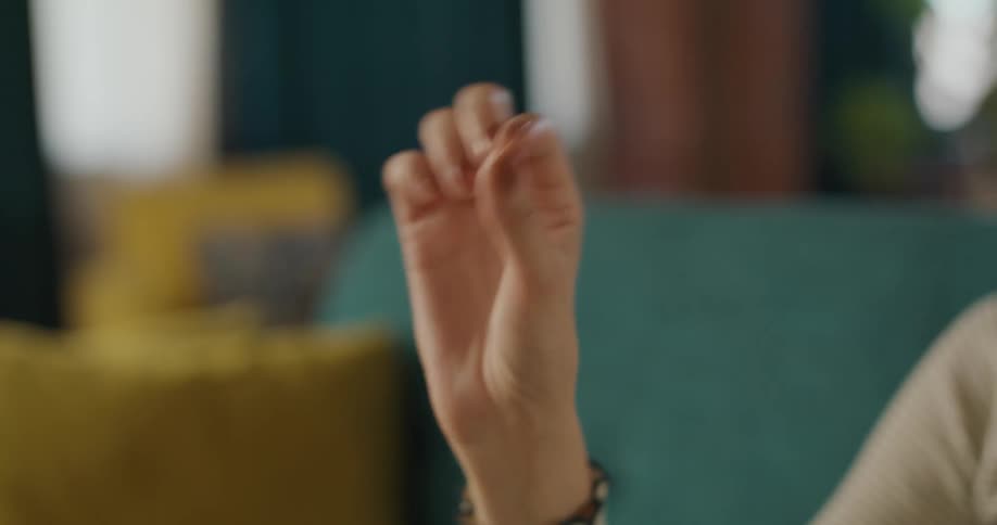 The woman points and pinches her fingers together