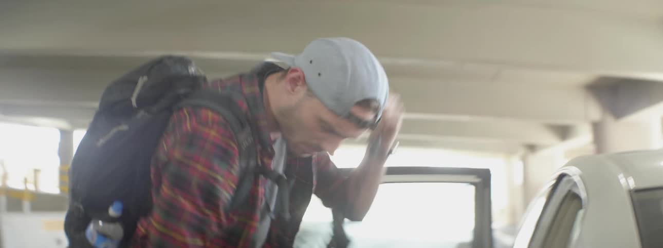 A man is loading items into a car