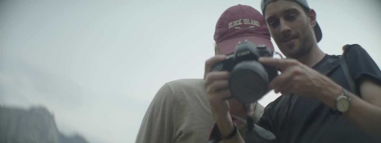 Two men look at a camera