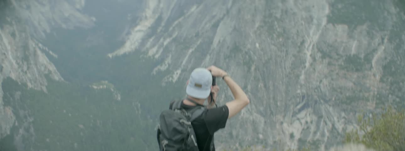 Man taking photographs of half dome in yosemite national forest