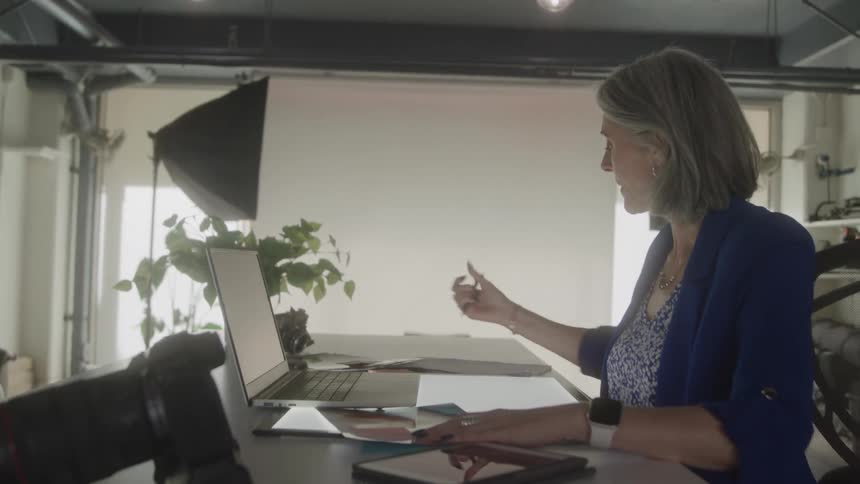 The woman is working in her office
