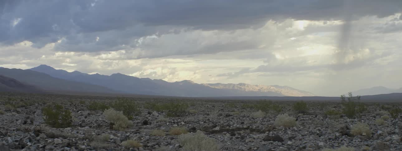 Clouds float over mountains in the distance