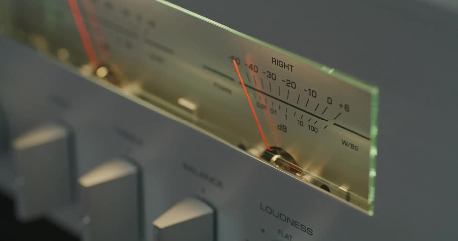 A vintage stereos rightchannel vu meter shows a red needle sweeping across the db scale