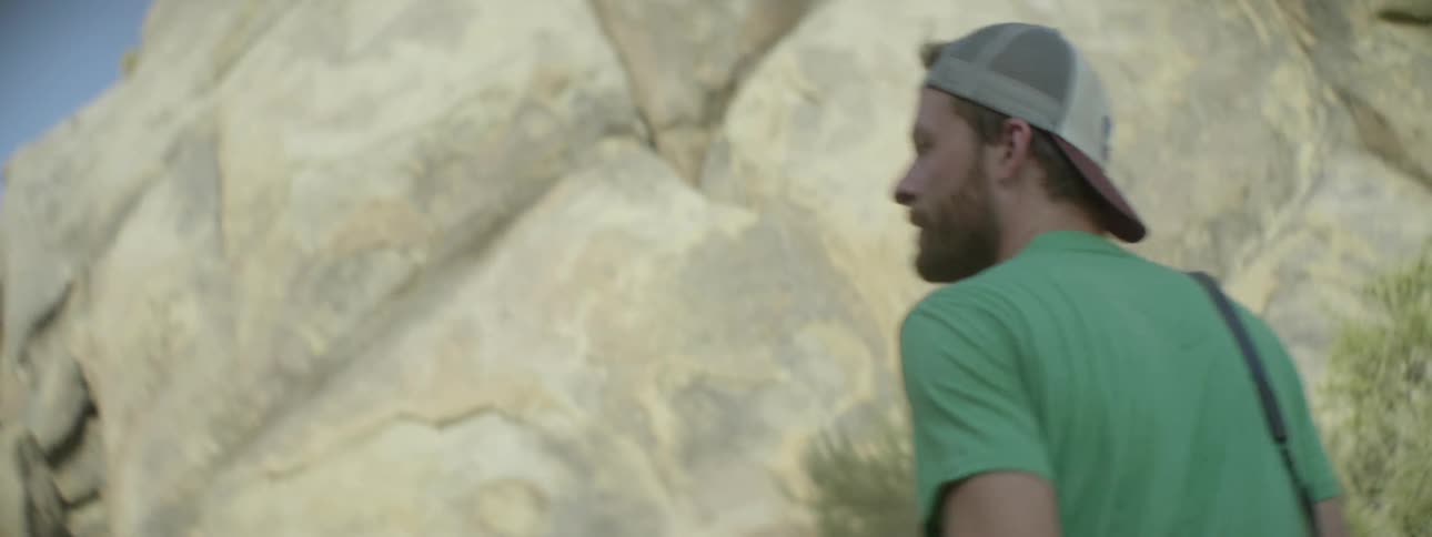 A man is hiking by a canyon