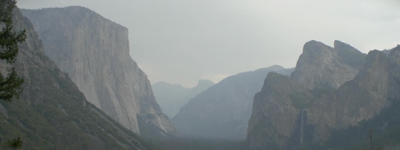 The mountains ahead are surrounded by light fog