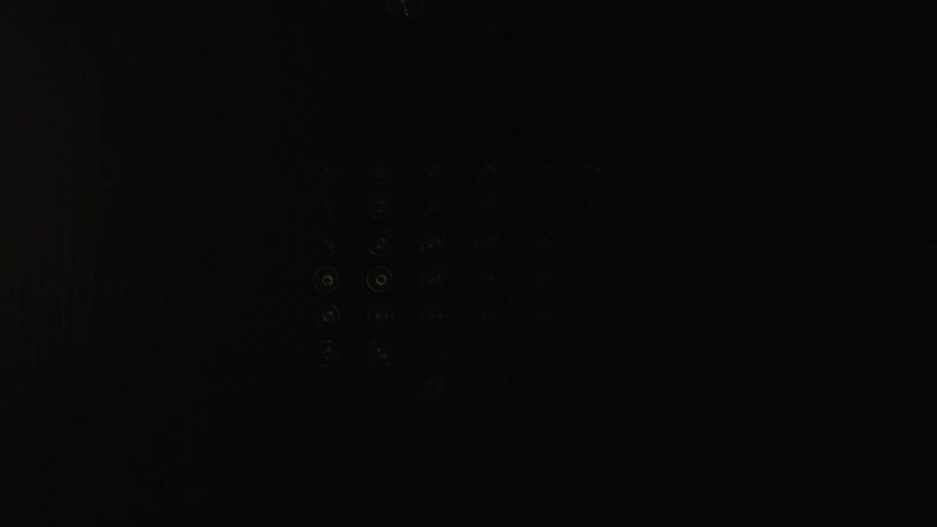 Flashing lights on the back wall of a dark room in a studio garage