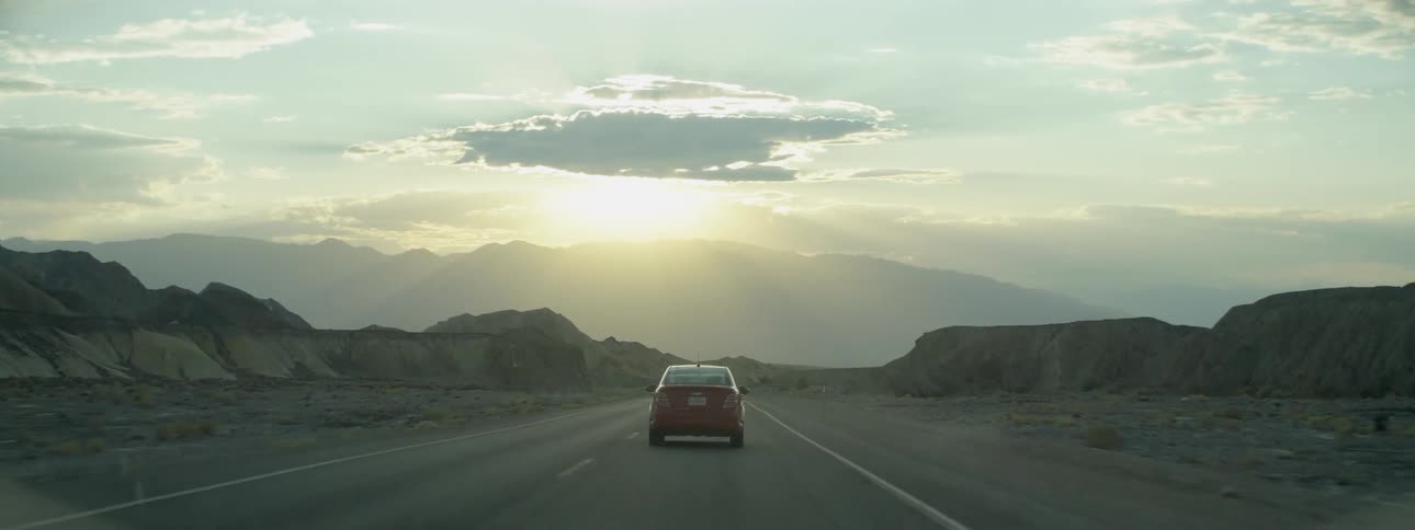 Car drives down a country road