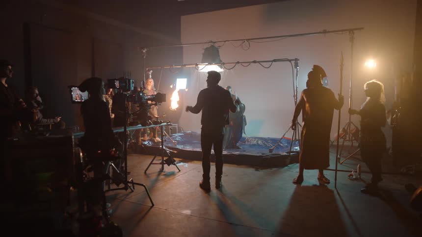 Actor and film crew create a scene in a period action movie