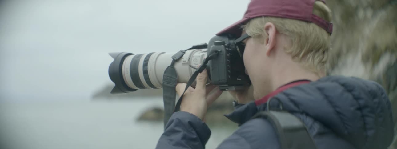 A man is taking photographs of the ocean