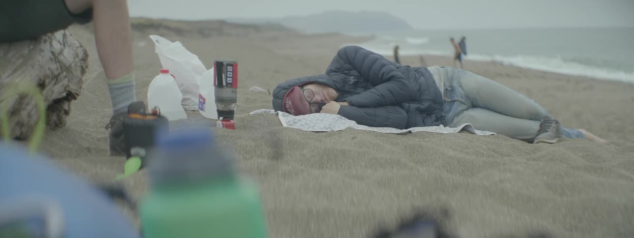 Man sleeping on a sandy beach
