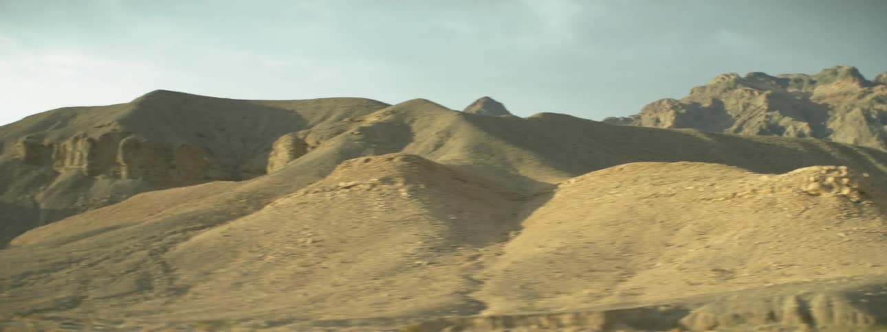 A hilly landscape is shown in the distance