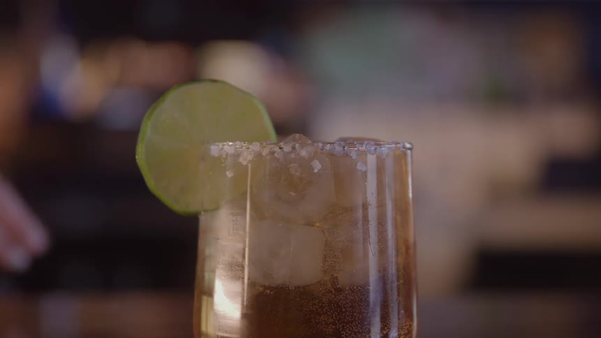 A person garnishes a glass