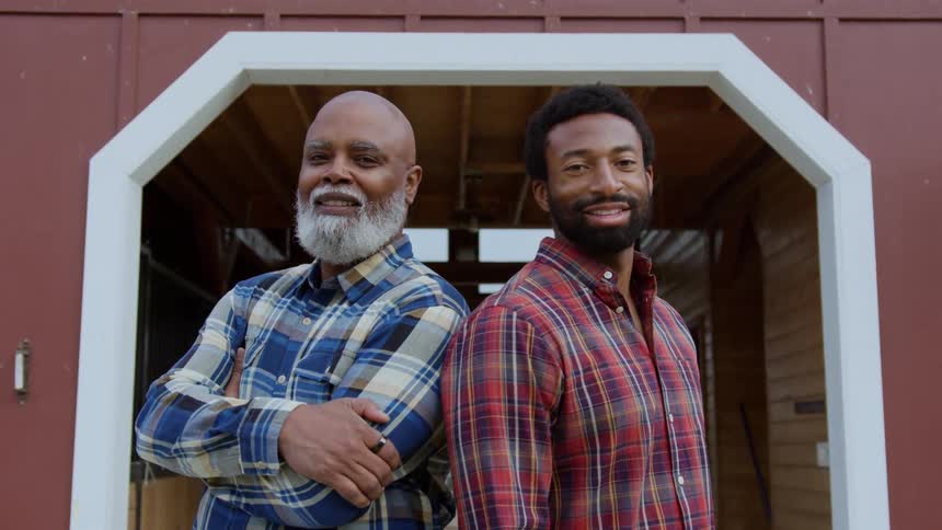 Portrait of black old man and son standing outdoors during daytime