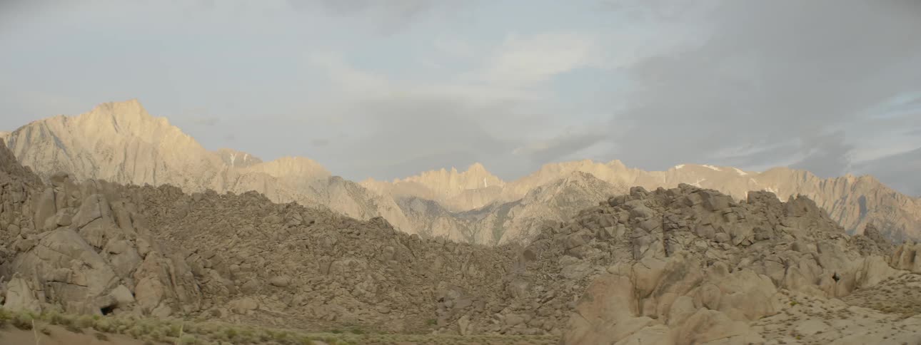 Clouds float over a rocky mountain ridge