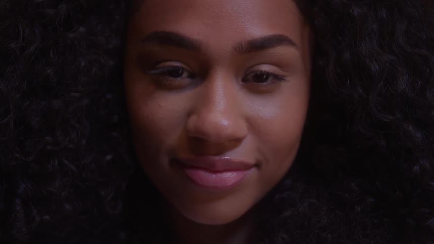 Woman with curly hair smiles