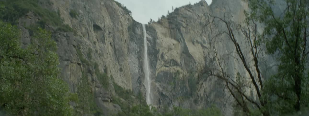 A waterfall cascades over a rocky cliff