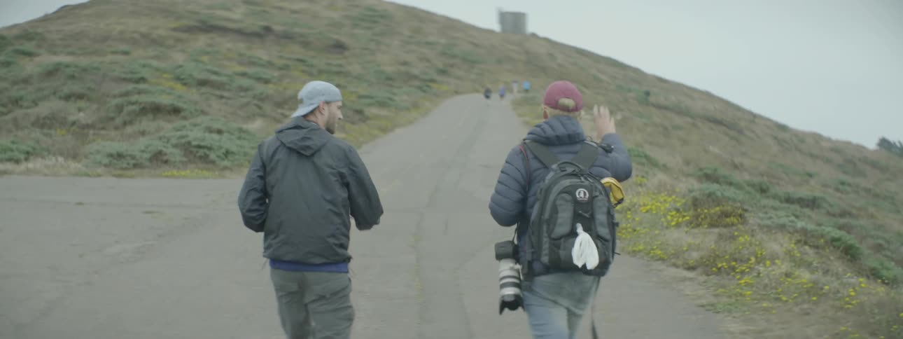 Two men walking on a path up the side of a hill