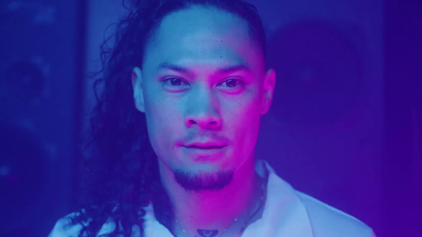 A man in a room with colorful lighting