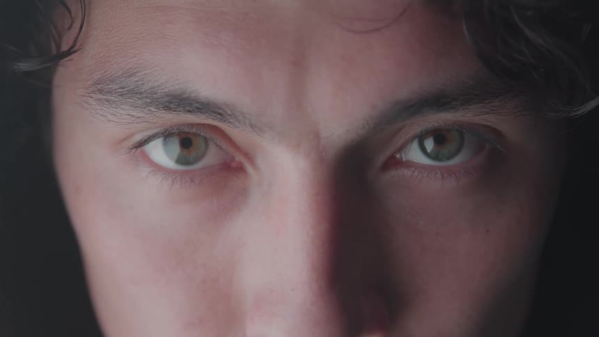 The man quickly blinks his eyes