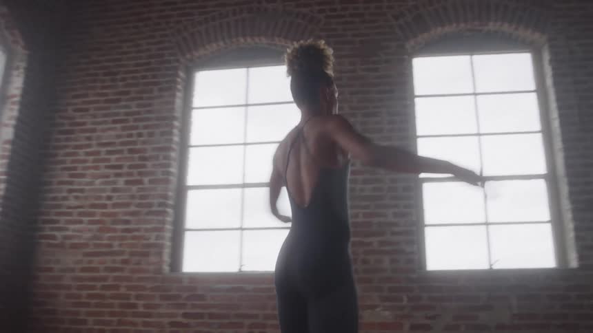 A dancer dancing alone in a room