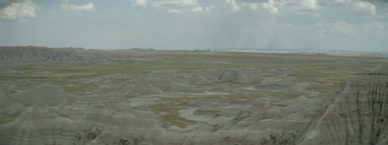 A long field has large rocks all over
