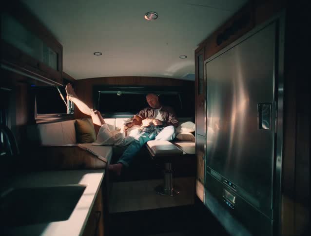 Couple relaxes together in a van lit by the soft evening light