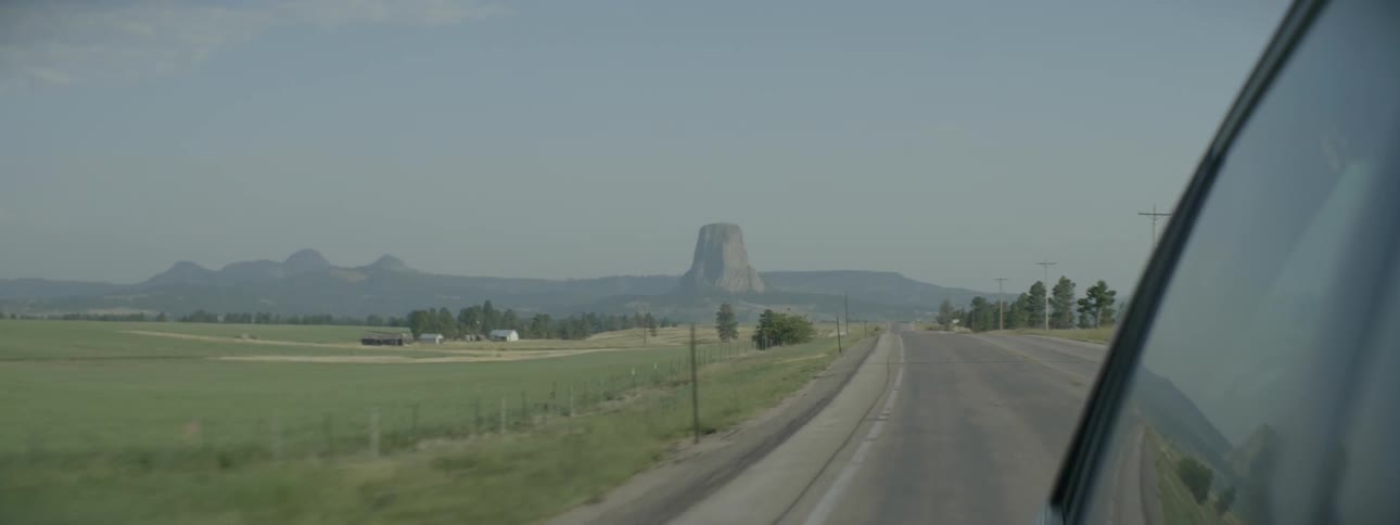 A car drives on a rural road