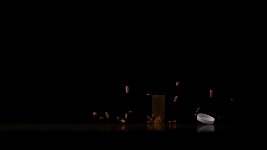 A bottle of pills is dropped and they launch upwards upon contact