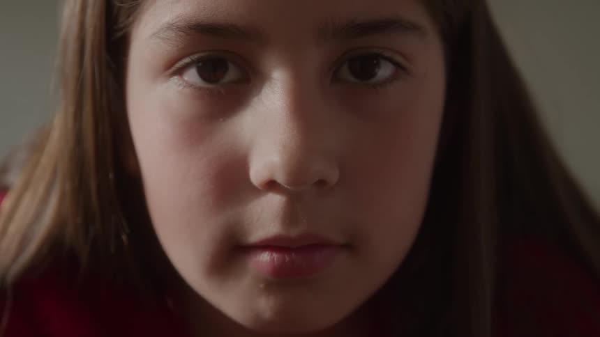 Closeup of a young girl looking directly into the camera