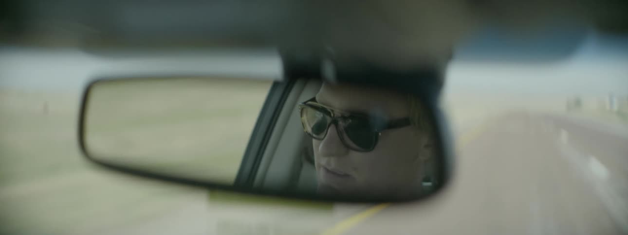 Man driving car down a highway