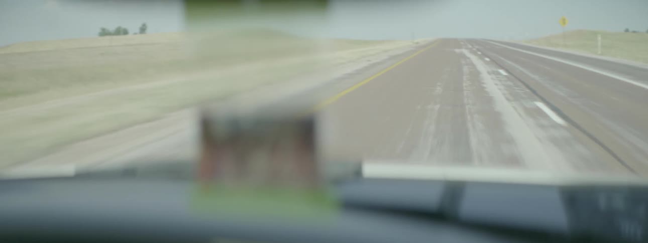 Car traveling on highway on sunny day