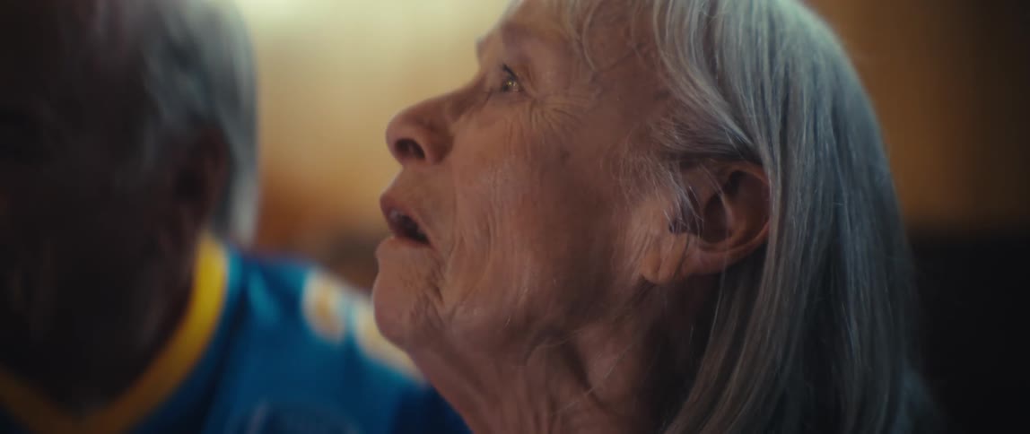 Elderly couple smiling and celebrating excitedly