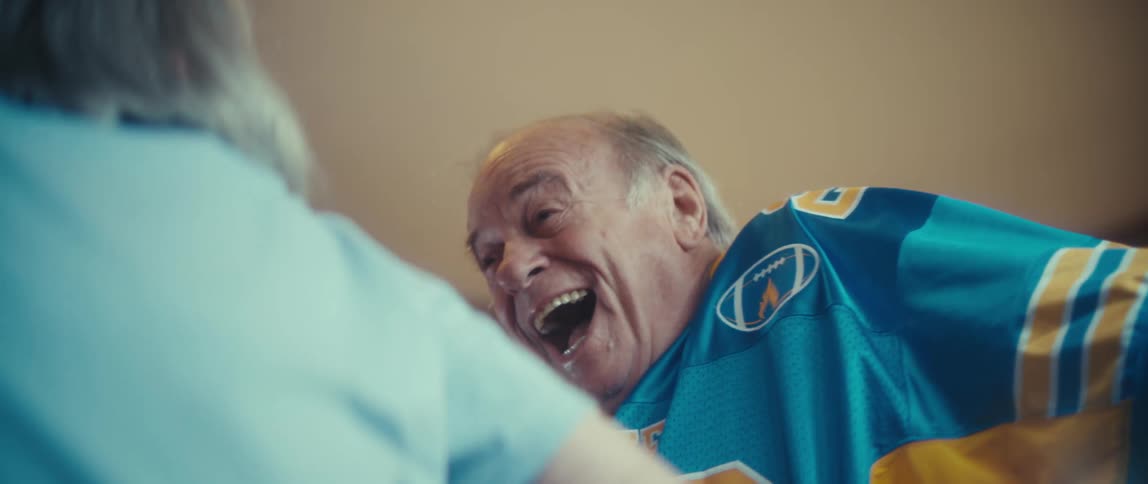 Man in sports jersey smiles at woman