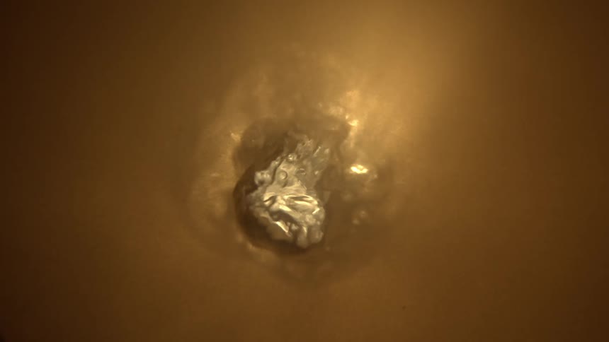 The yellow liquid bubbles up