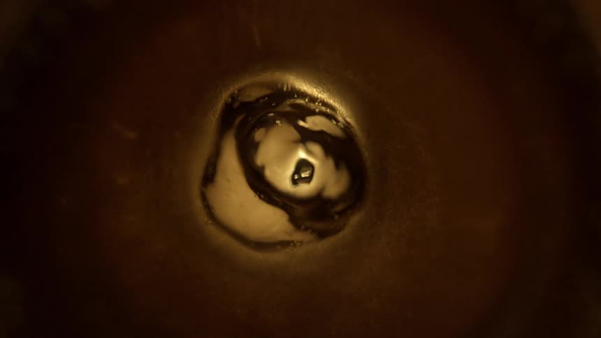 Light shines through brown liquid