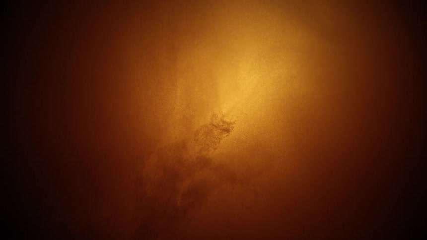 Liquid bubbles forming a dense cloud illuminated by golden light
