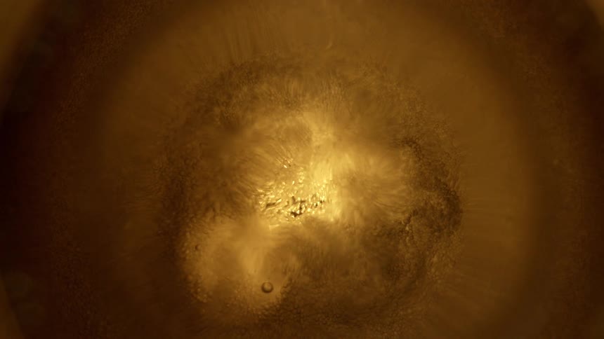 Light shines through brown liquid