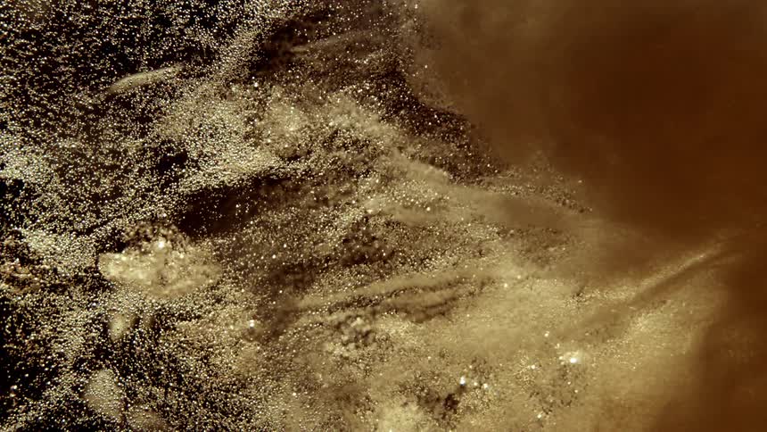 Foam moves in the golden liquid