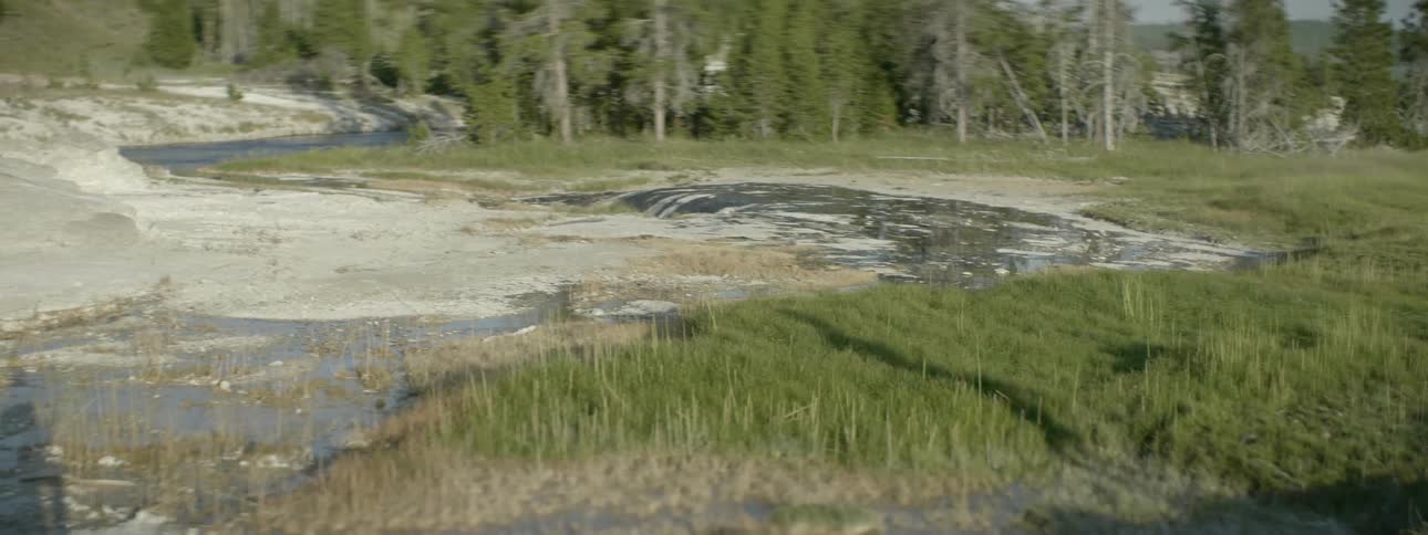 A hiker's shadow is cast onto the ground