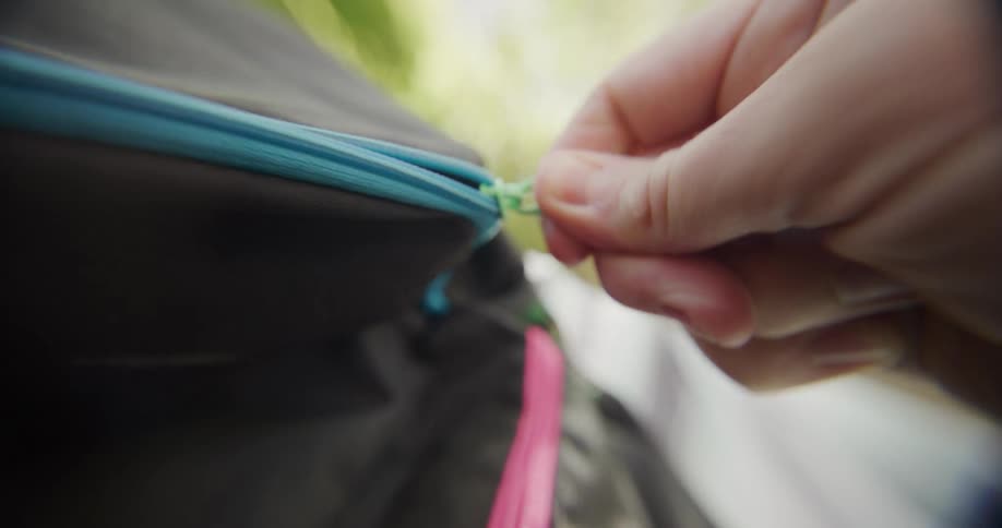 A person zips up a bag