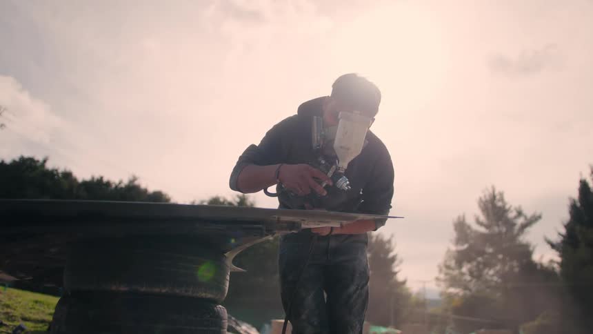 Person performs manual work with protective equipment sanding