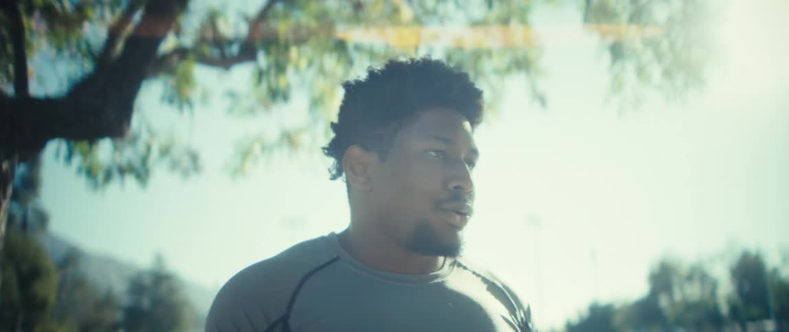 Man breathes deeply while standing in a park on a sunny day in autumn
