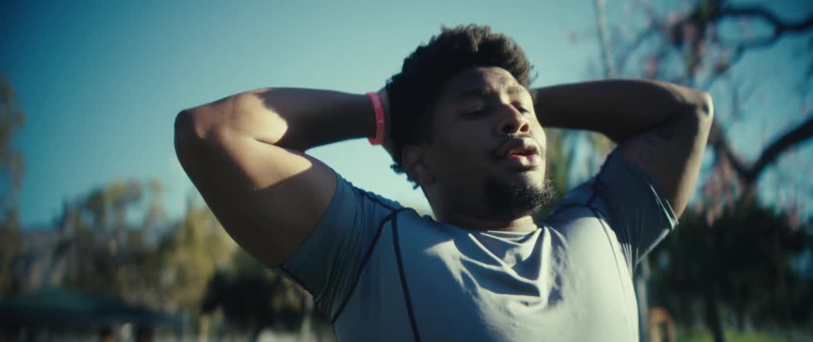 Man takes a deep breath after training under the morning sun