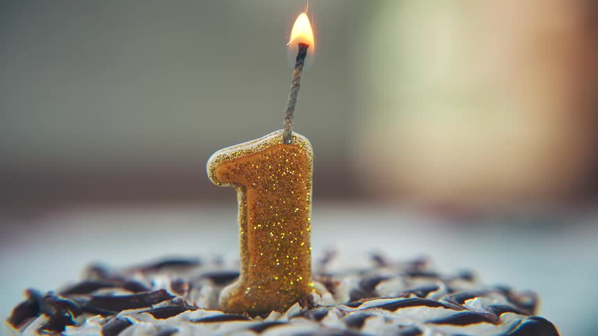A number one candle is lit