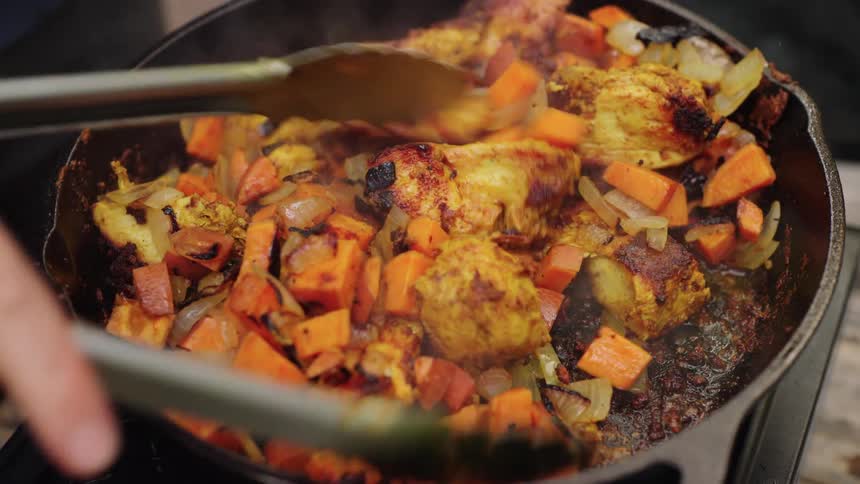 Sauted chicken sweet potato and onion in cast iron skillet