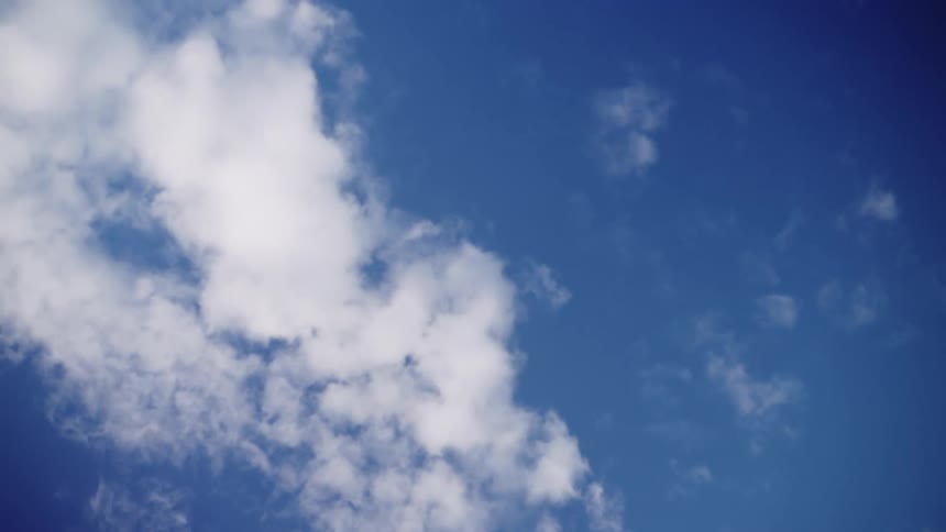 White clouds contrast with the blue sky they float across